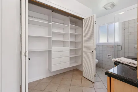 a bathroom with a granite countertop sink a toilet and bathtub