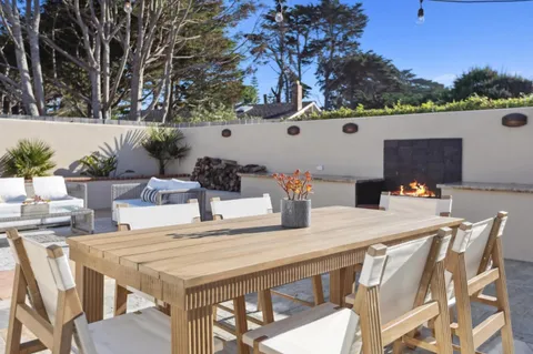 a view of a chairs and tables in the back yard of the house