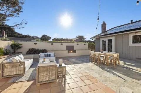 a view of a patio with table and chairs and potted plants