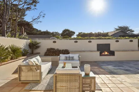 a view of a patio with table and chairs and potted plants