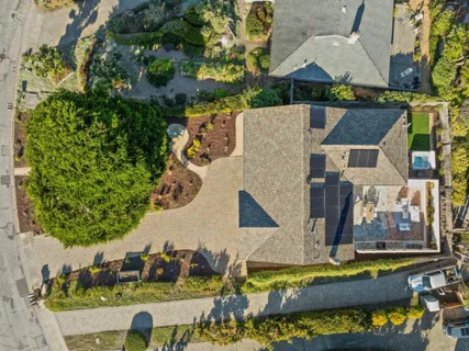 an aerial view of a house with a swimming pool