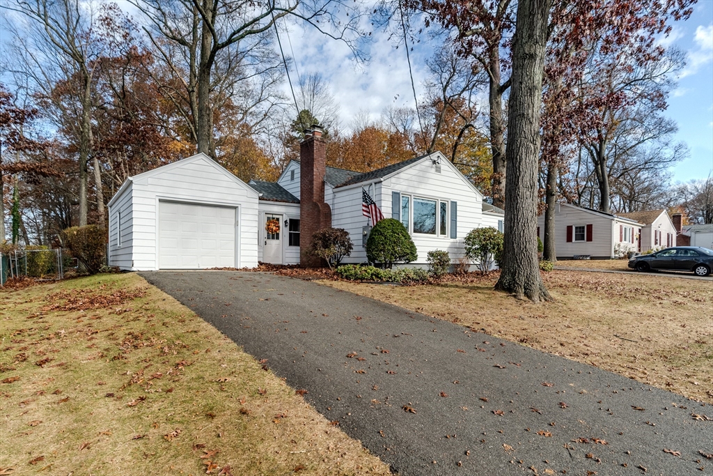 14 Hadley Street Springfield, MA 01118 - Photo 2 of 28 a front view of a house with a dirt yard and a large tree