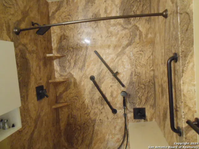 a white toilet sitting next to a bath tub