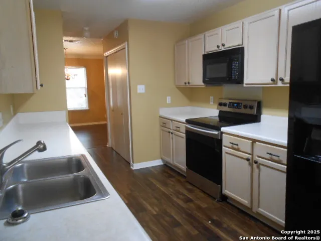 a bathroom with a granite countertop sink a mirror and a shower