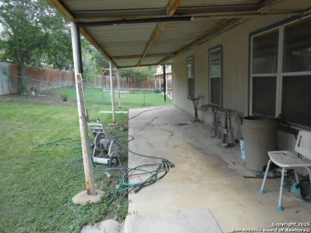 a view of a porch with chairs and backyard