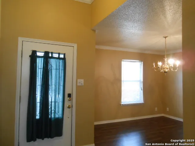 a kitchen with granite countertop white cabinets stainless steel appliances and a sink