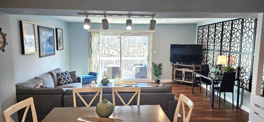 1788 Windlass Road, Unit C4 Moneta, VA 24121 - Photo 20 of 79 a living room with furniture a flat screen tv and a floor to ceiling window