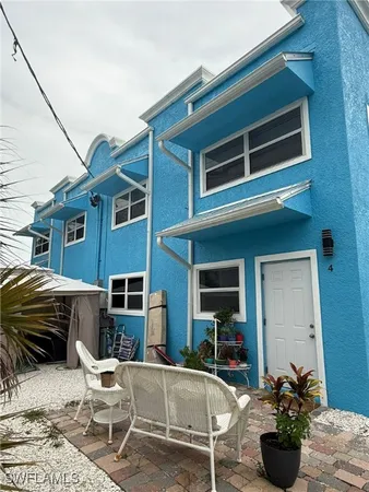 a building outdoor space with patio furniture and potted plants
