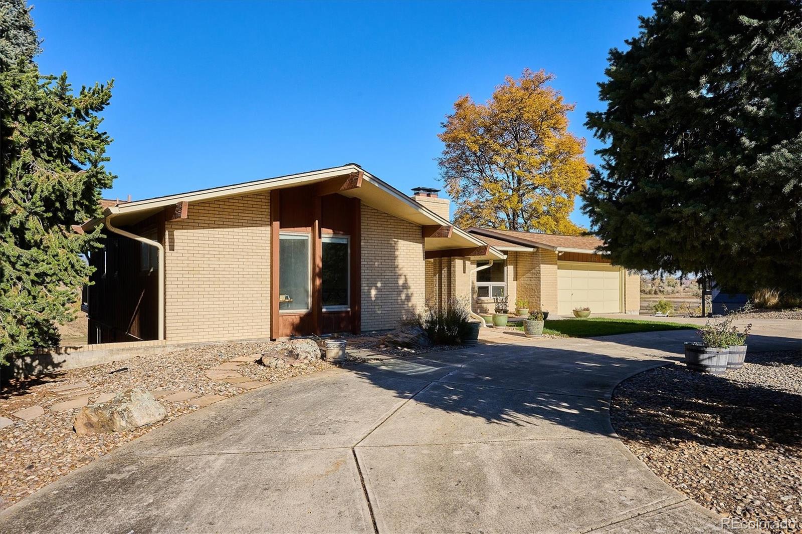 14935 West 58th Place Golden, CO 80403 - Photo 1 of 31 a front view of a house with a yard and trees