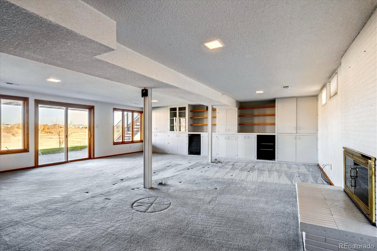 14935 West 58th Place Golden, CO 80403 - Photo 15 of 31 a view of a livingroom with a fireplace and window