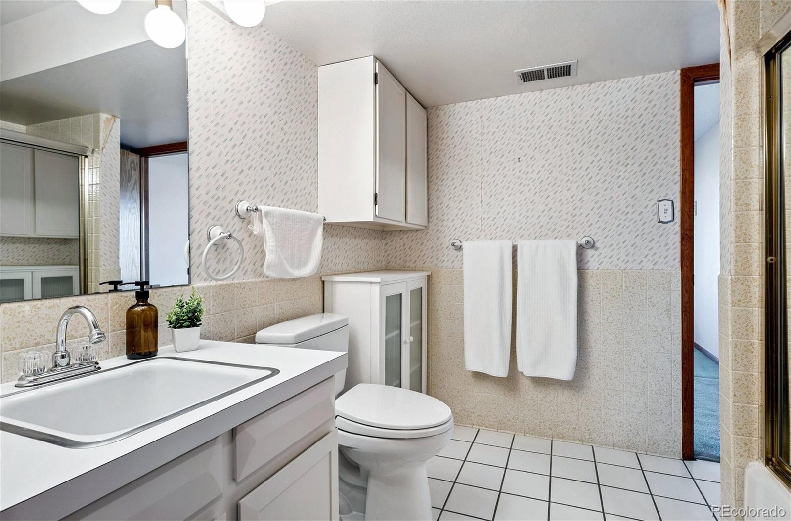 14935 West 58th Place Golden, CO 80403 - Photo 19 of 31 a bathroom with a sink toilet and shower
