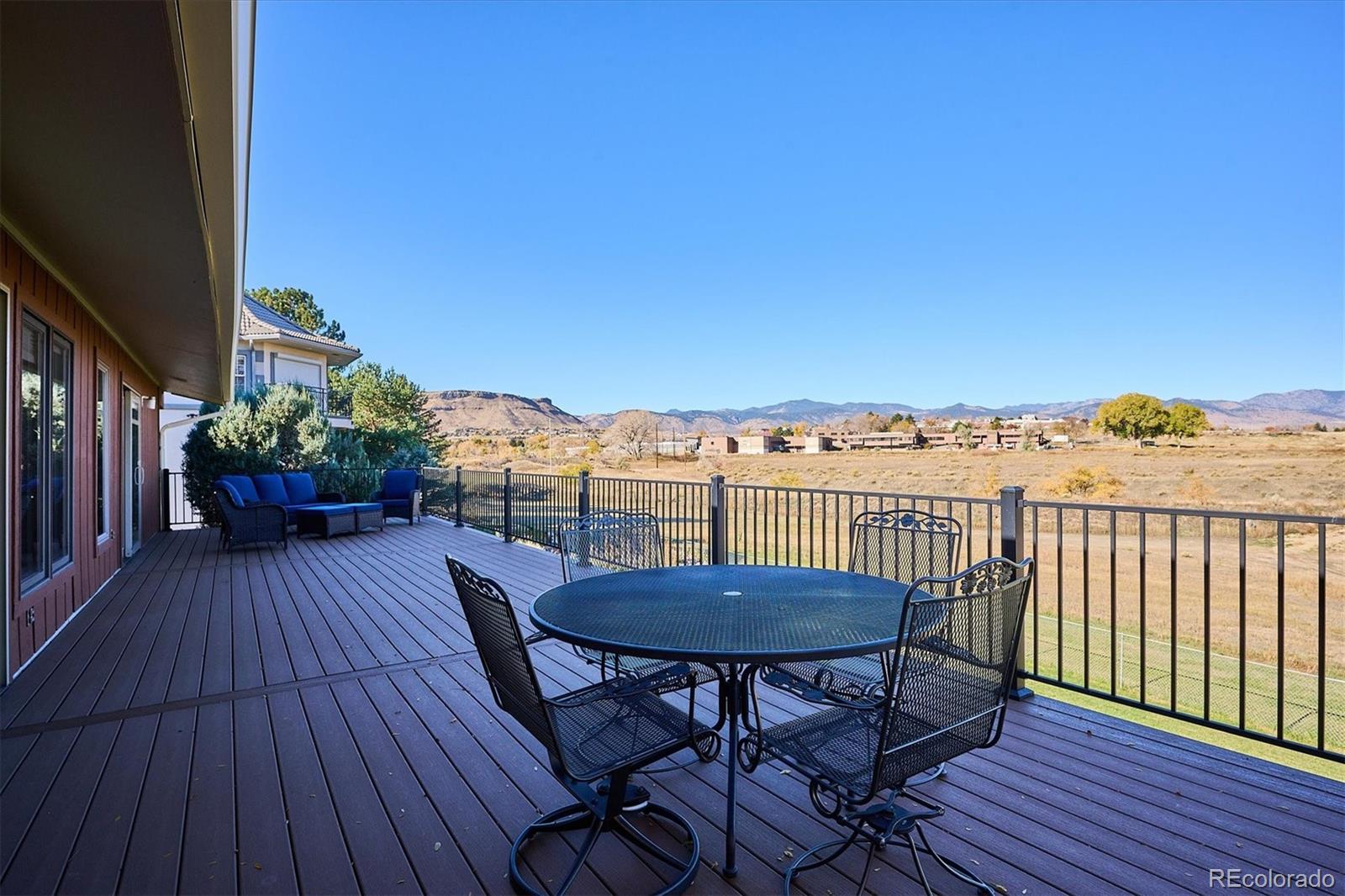 14935 West 58th Place Golden, CO 80403 - Photo 21 of 31 a view of a balcony with furniture and wooden floor