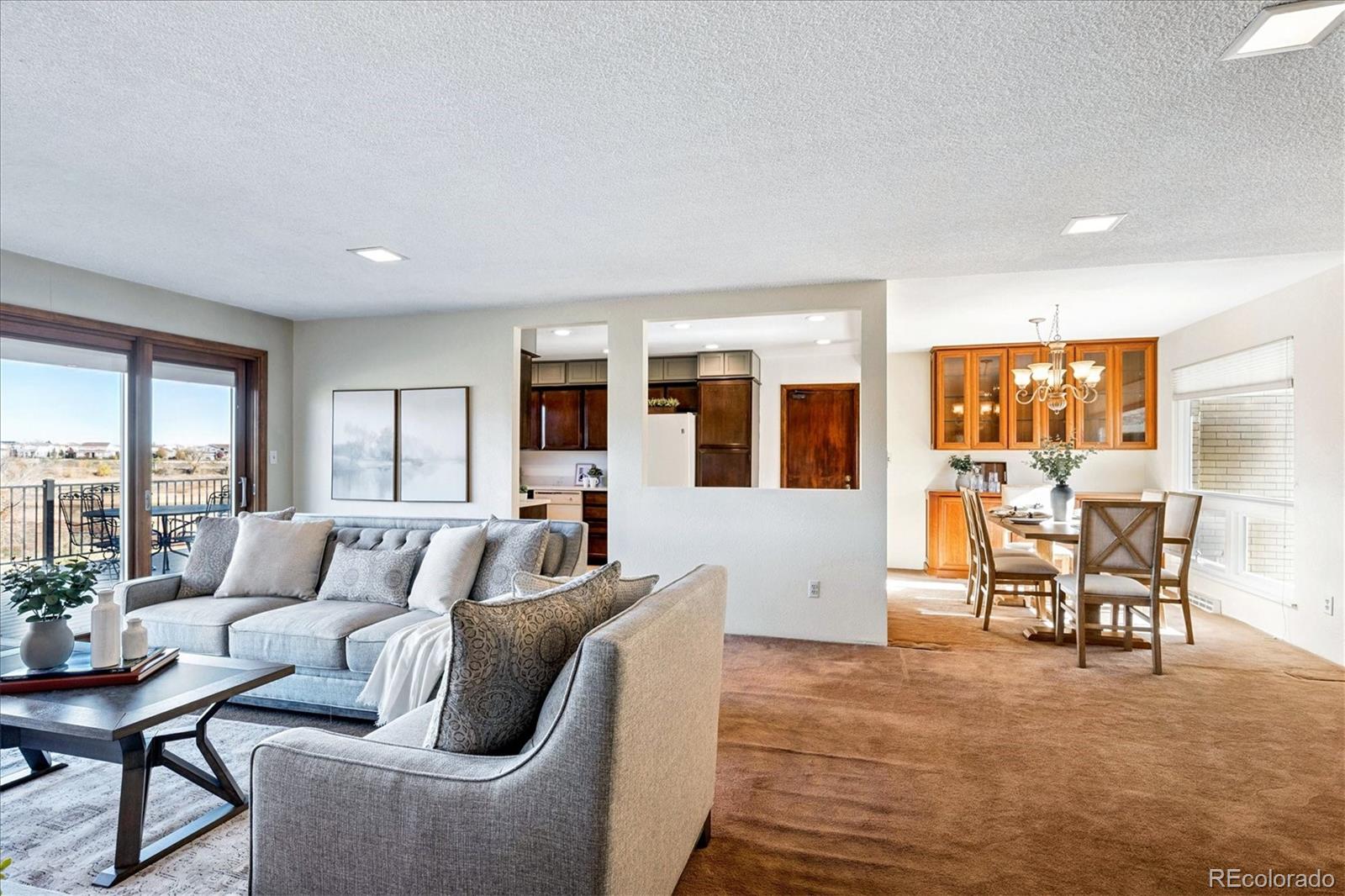 14935 West 58th Place Golden, CO 80403 - Photo 5 of 31 a living room with furniture and large windows