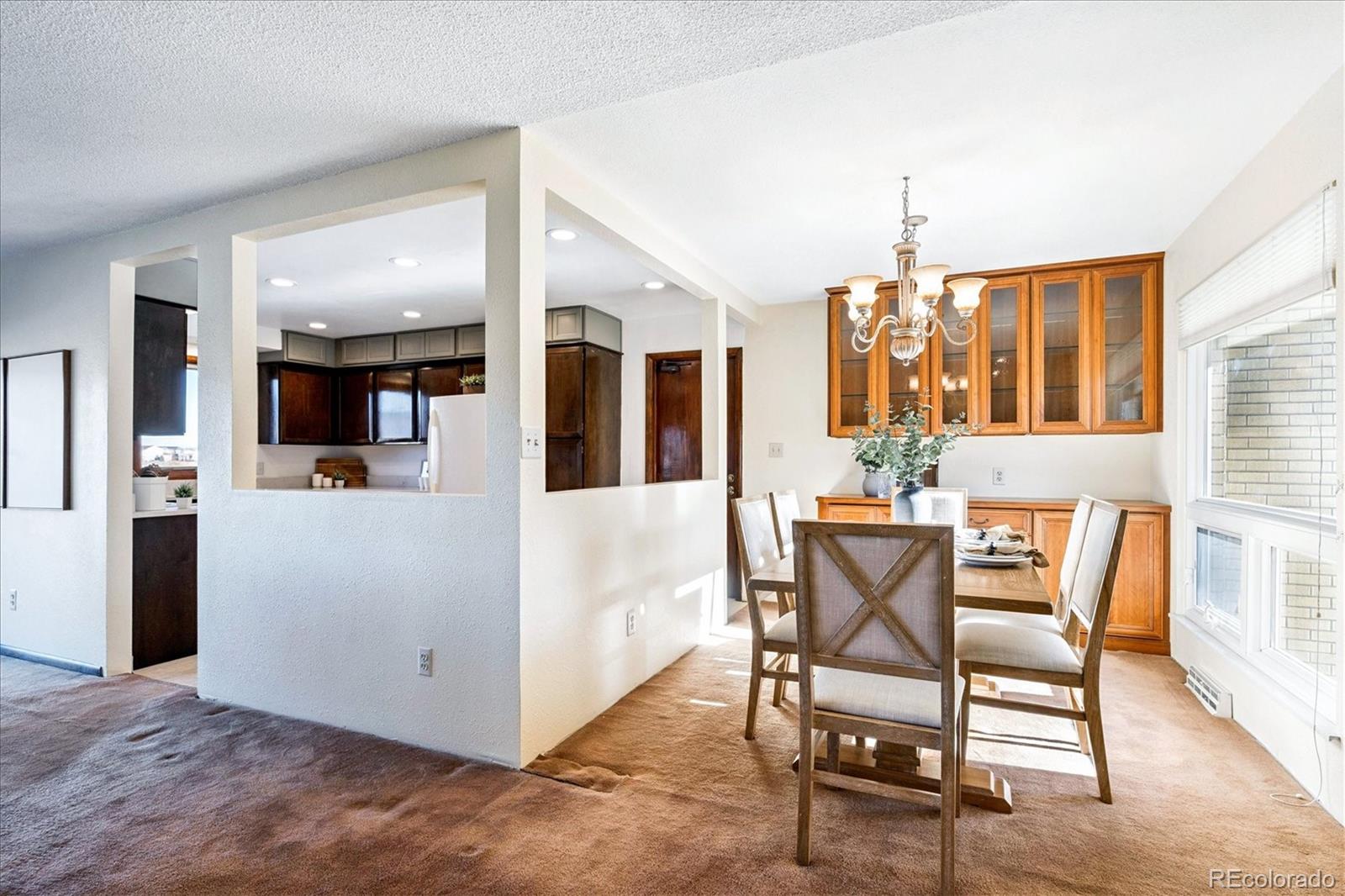 14935 West 58th Place Golden, CO 80403 - Photo 6 of 31 a view of a dining room with furniture and wooden floor