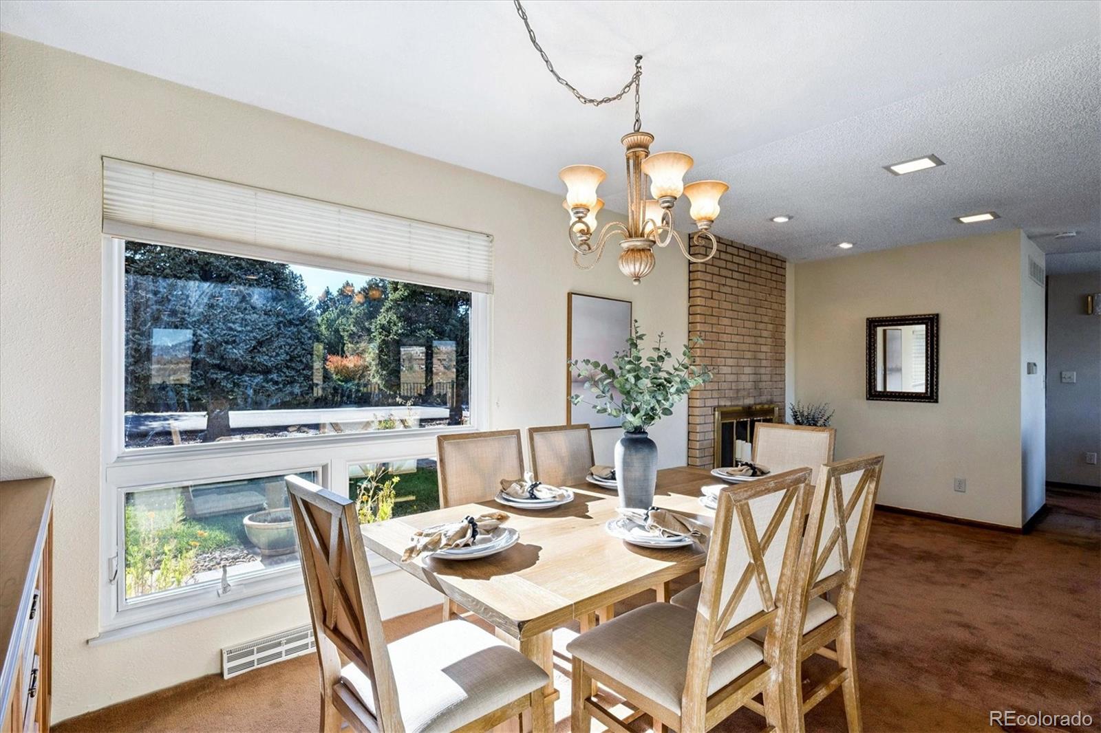 14935 West 58th Place Golden, CO 80403 - Photo 7 of 31 a view of a dining room with furniture window and outside view