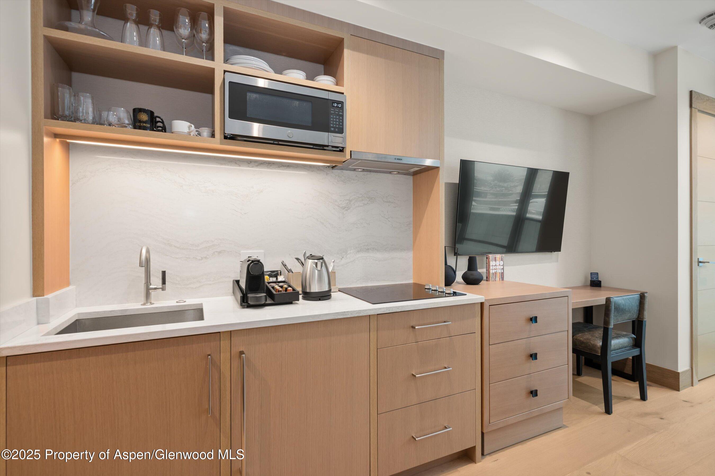 130 Wood Road, Unit 353355 Snowmass Village, CO 81615 - Photo 11 of 41 a kitchen with cabinets and window