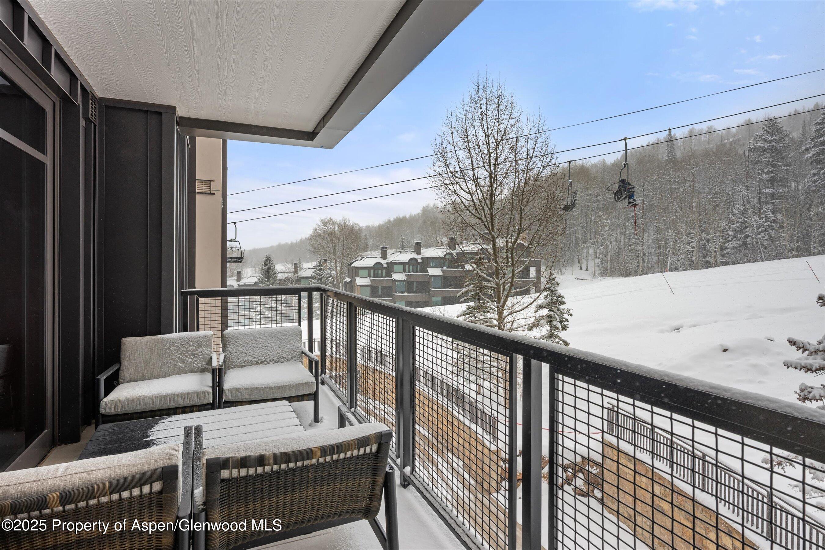 130 Wood Road, Unit 353355 Snowmass Village, CO 81615 - Photo 17 of 41 a balcony with couches and wooden floor