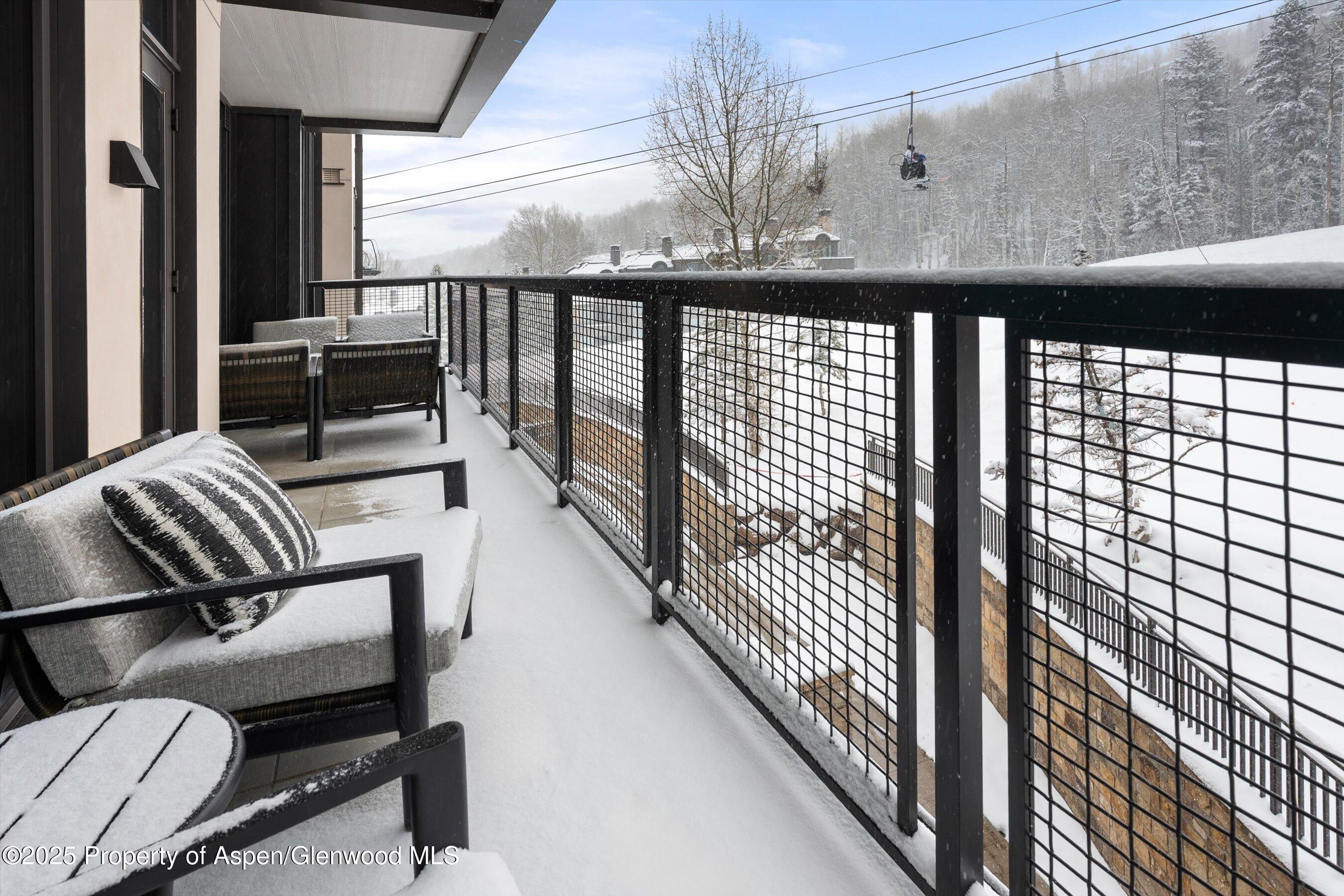 130 Wood Road, Unit 353355 Snowmass Village, CO 81615 - Photo 18 of 41 a view of a chairs and table in balcony