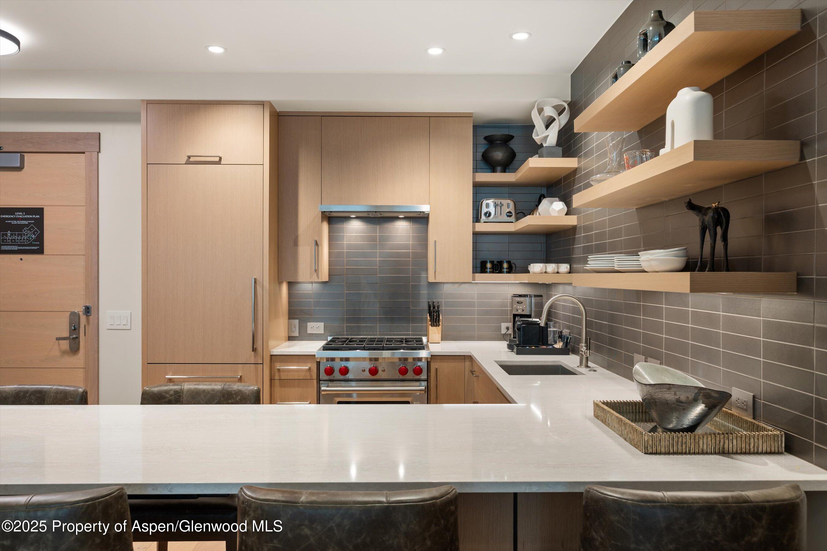 130 Wood Road, Unit 353355 Snowmass Village, CO 81615 - Photo 23 of 41 a kitchen with a refrigerator and a sink