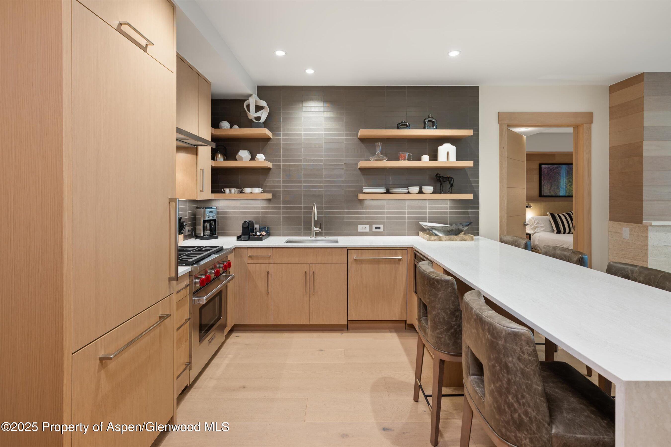 130 Wood Road, Unit 353355 Snowmass Village, CO 81615 - Photo 27 of 41 a kitchen with a sink stainless steel appliances and cabinets