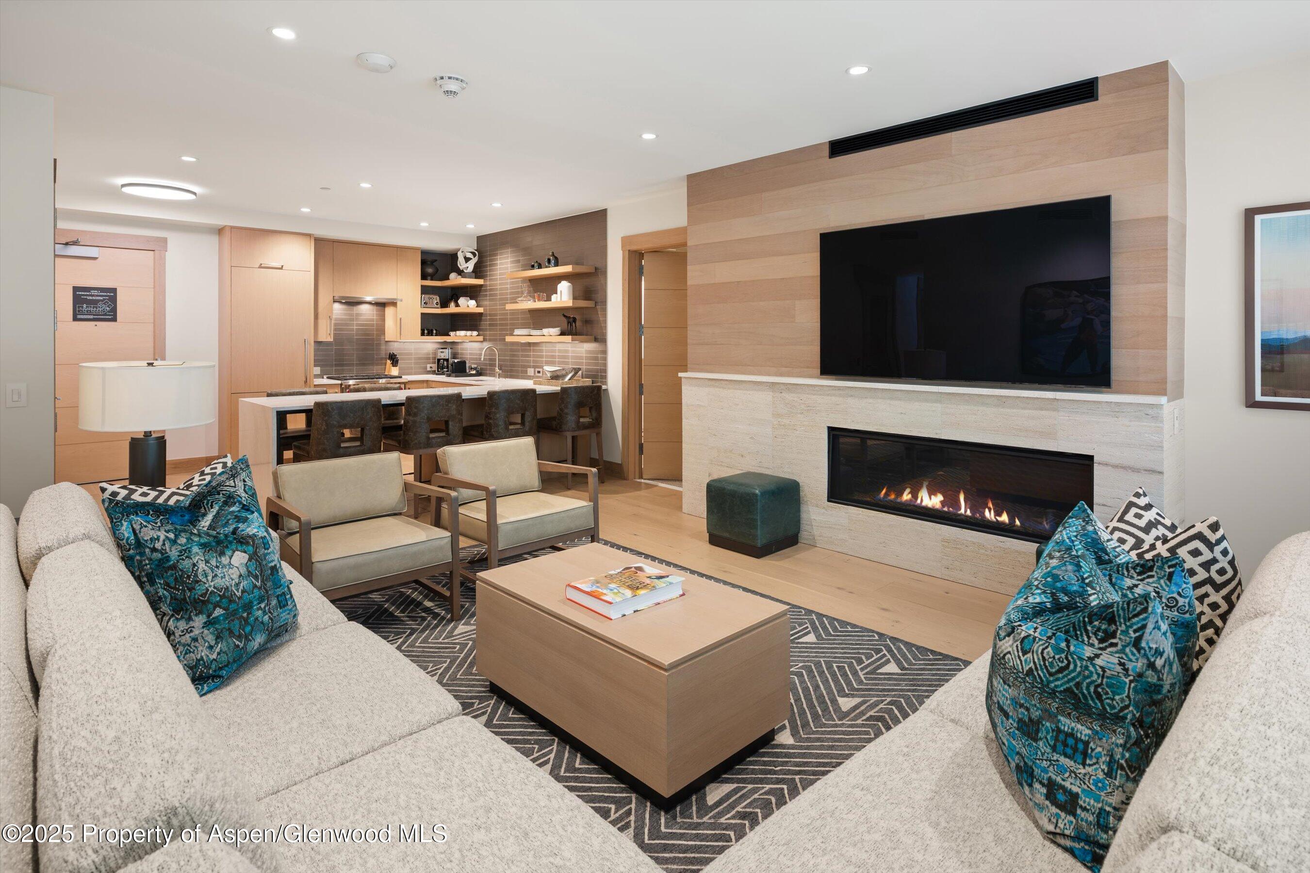 130 Wood Road, Unit 353355 Snowmass Village, CO 81615 - Photo 29 of 41 a living room with furniture and a fireplace
