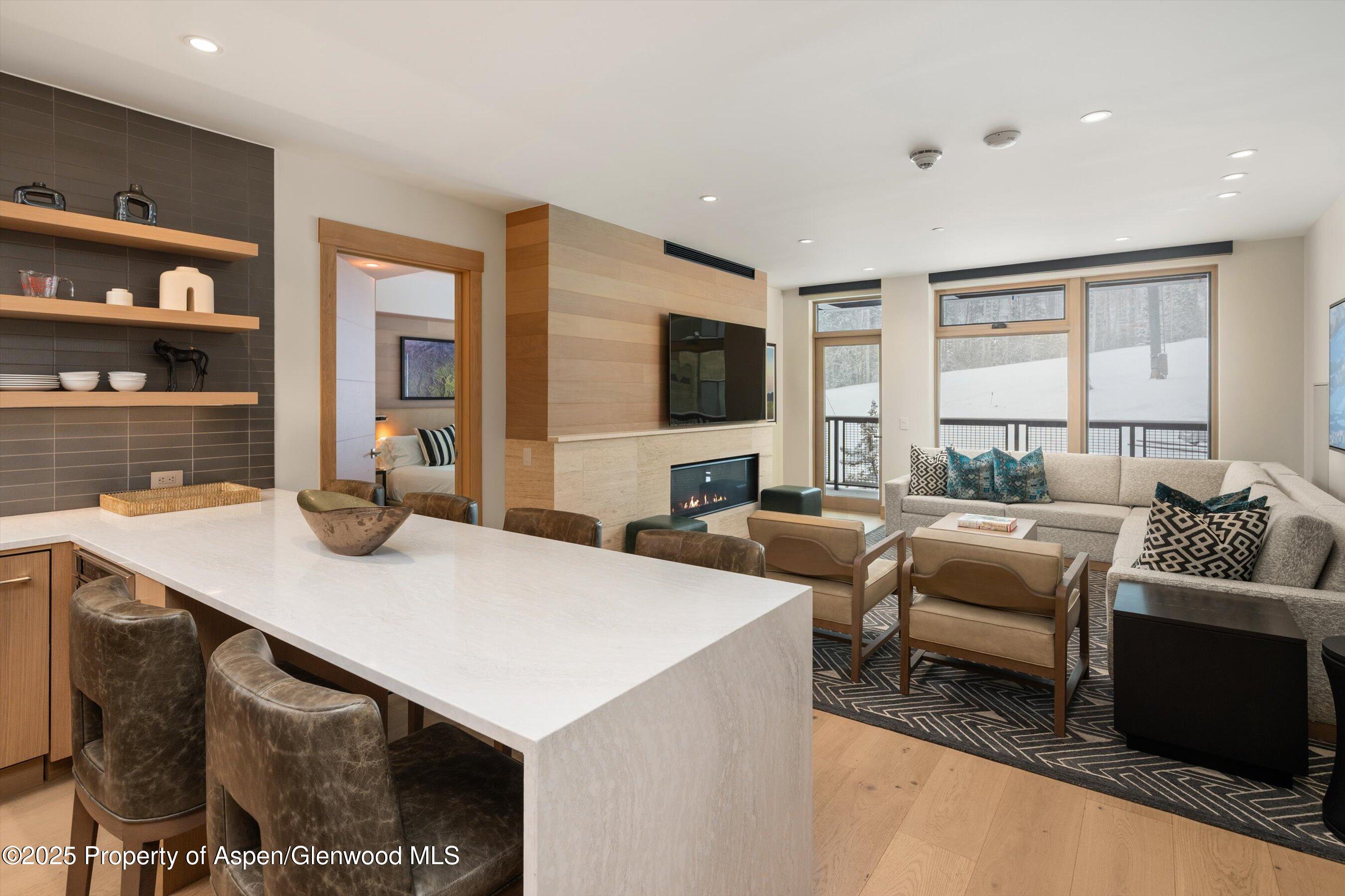130 Wood Road, Unit 353355 Snowmass Village, CO 81615 - Photo 3 of 41 a view of kitchen island a sink and living room