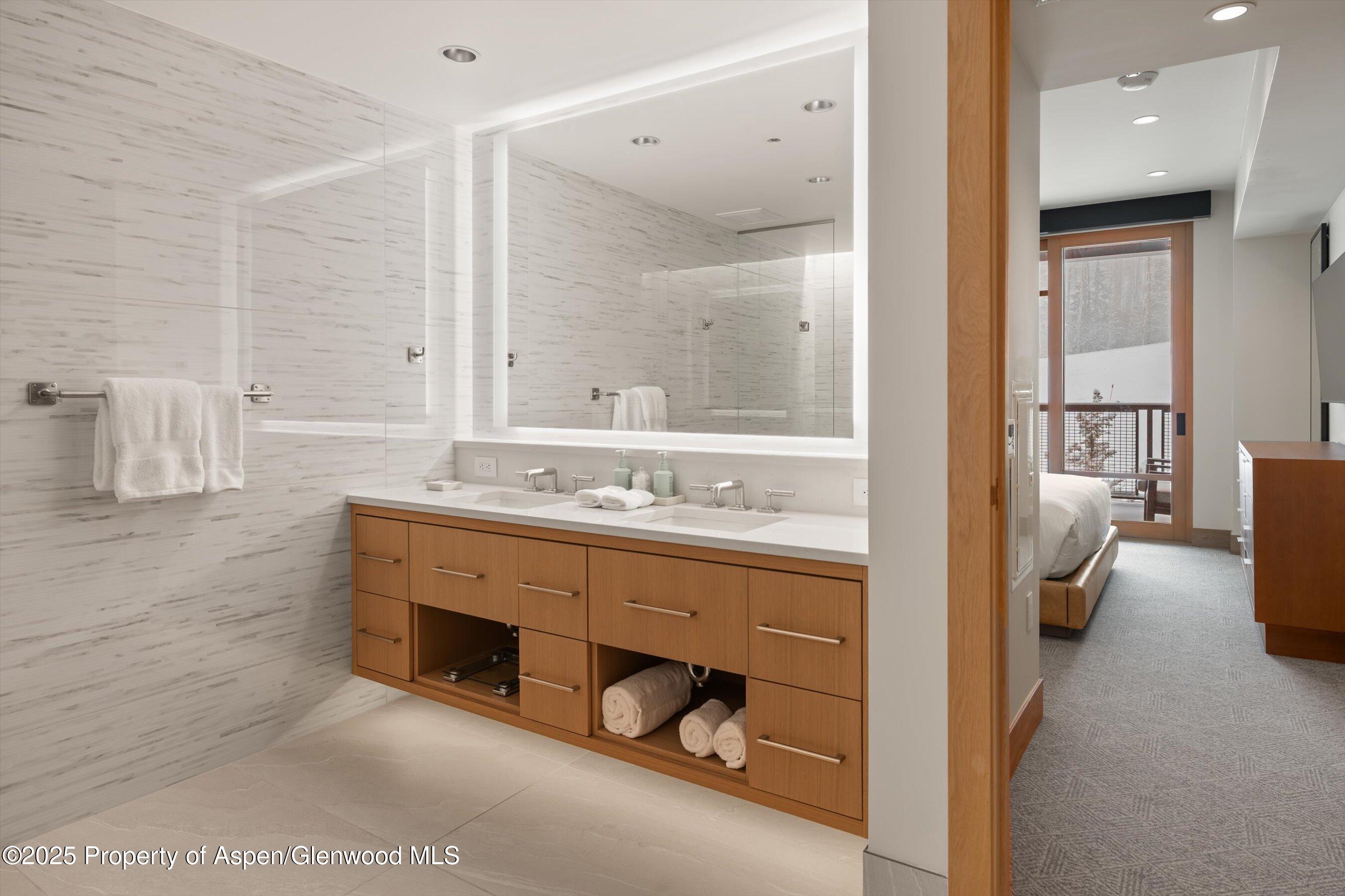 130 Wood Road, Unit 353355 Snowmass Village, CO 81615 - Photo 34 of 41 a bathroom with a tub sink and mirror