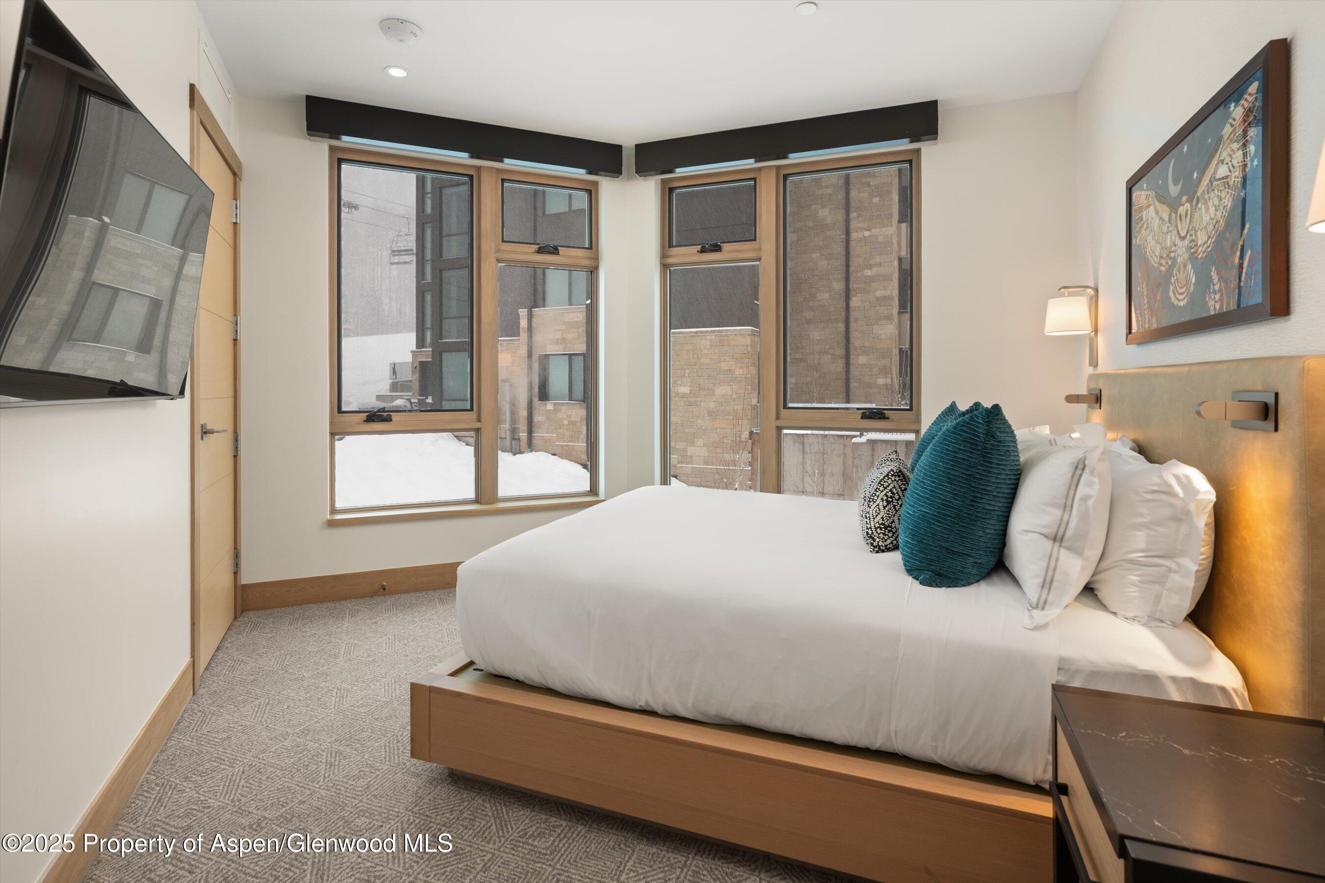130 Wood Road, Unit 353355 Snowmass Village, CO 81615 - Photo 38 of 41 a bedroom with a bed and a large window