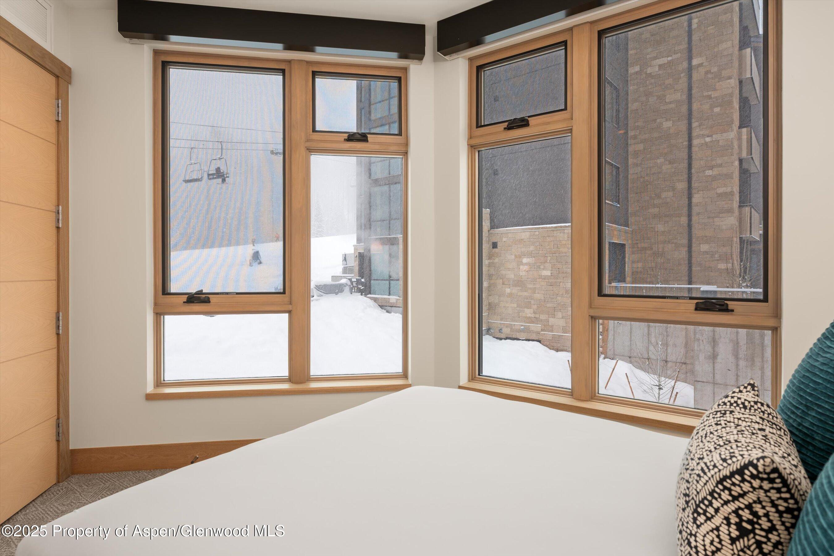 130 Wood Road, Unit 353355 Snowmass Village, CO 81615 - Photo 39 of 41 a bedroom with a bed and a window