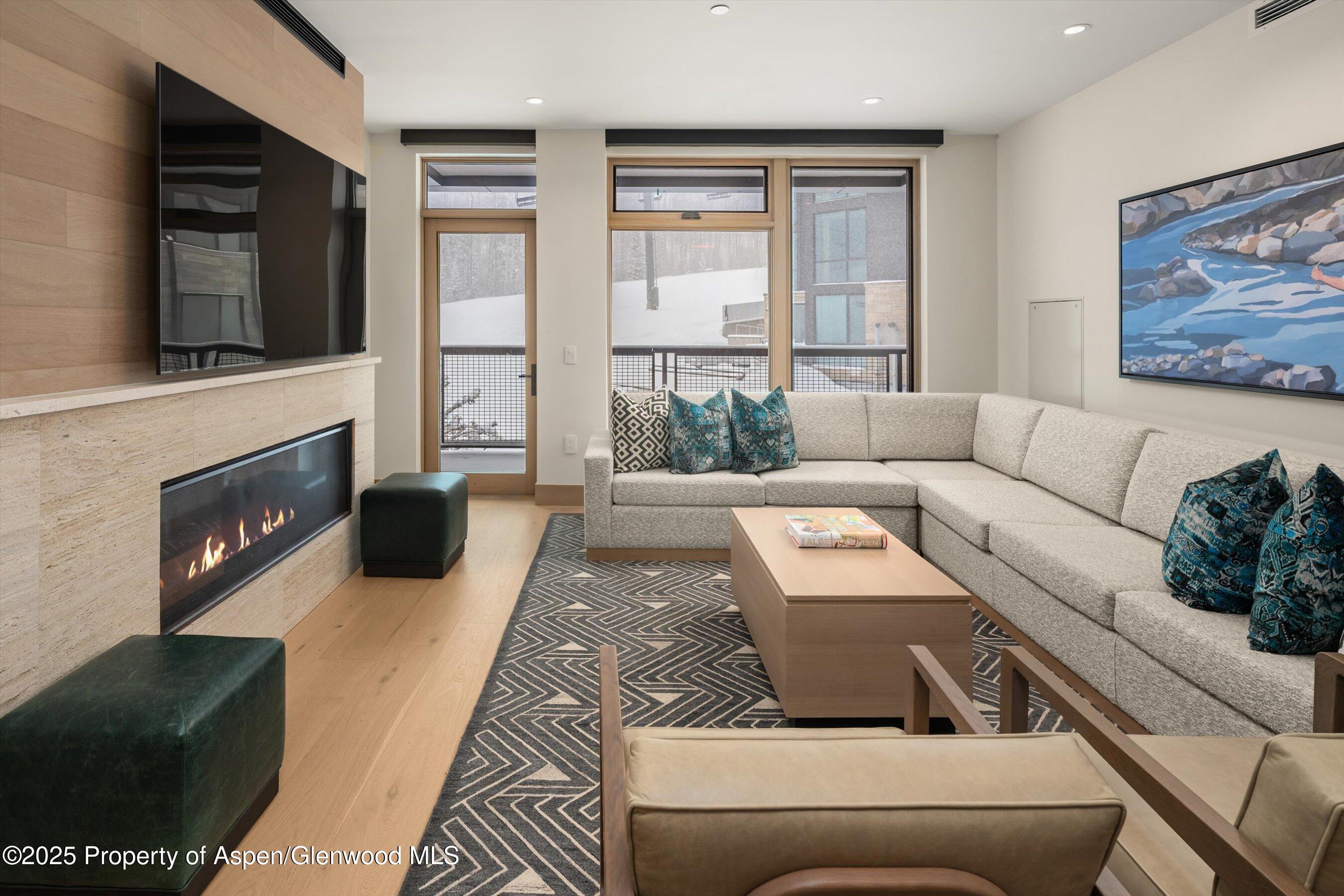 130 Wood Road, Unit 353355 Snowmass Village, CO 81615 - Photo 5 of 41 a living room with furniture and a fireplace