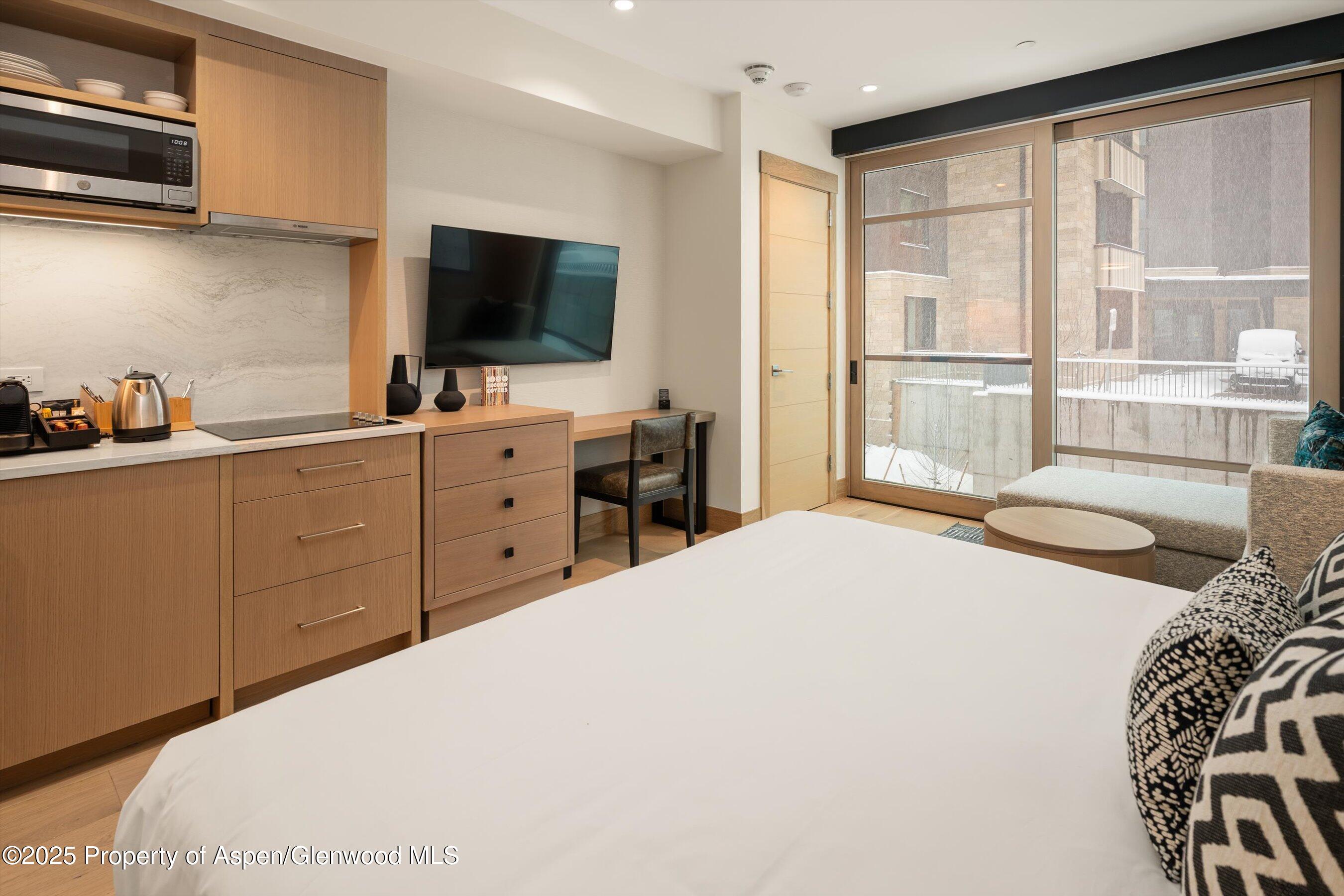 130 Wood Road, Unit 353355 Snowmass Village, CO 81615 - Photo 10 of 41 a bedroom with a bed and a flat screen tv