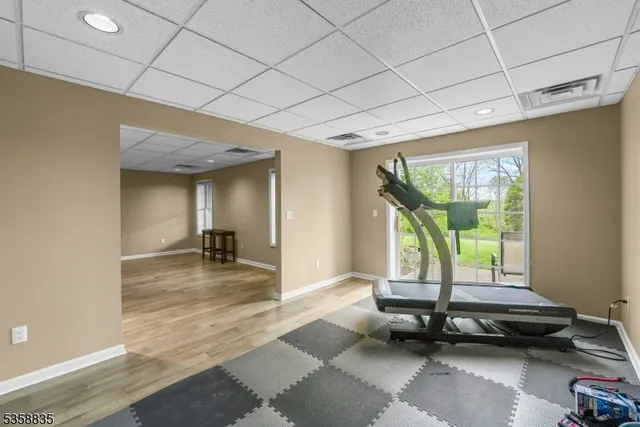 a living room with a couch and floor to ceiling window
