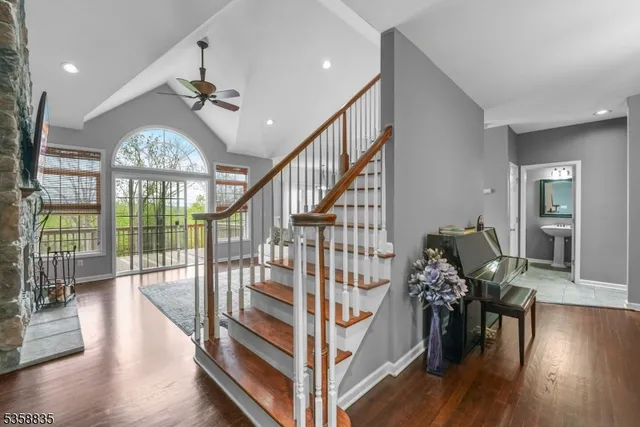 a view of entryway livingroom and hall with wooden floor