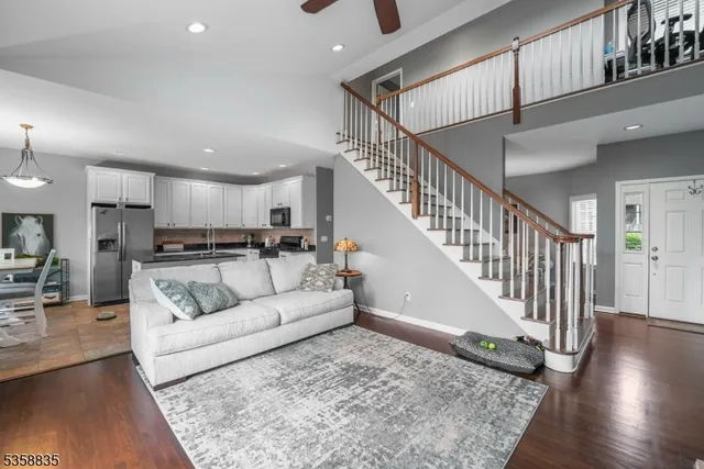 a living room with furniture and kitchen view