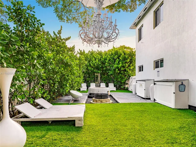 a view of a house with backyard and a patio
