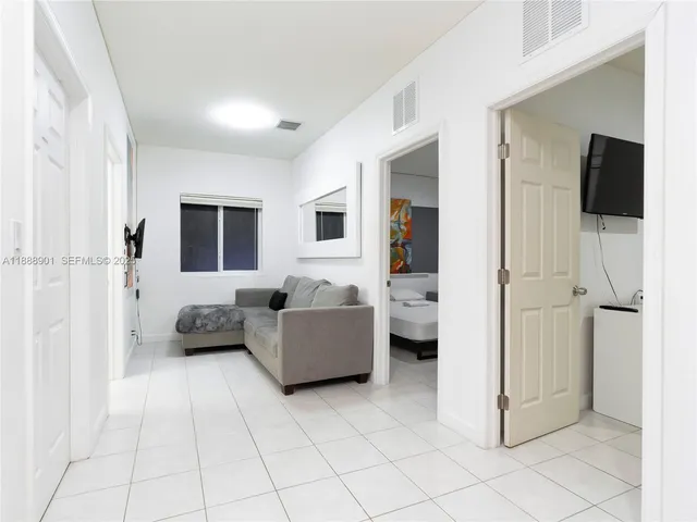 a bedroom with a bed and a couch