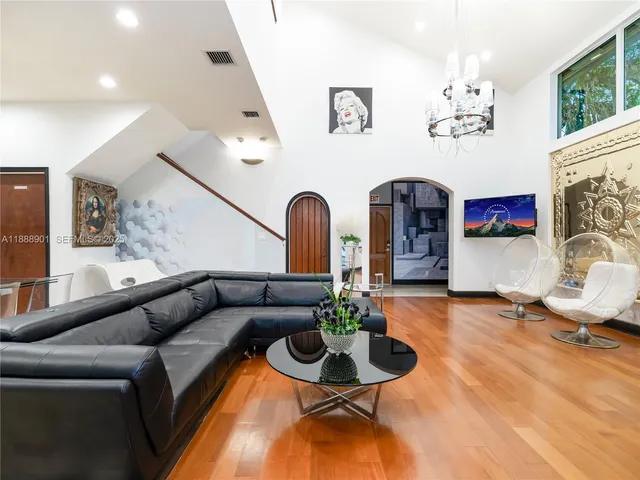 a living room with furniture flowerpot and a fireplace