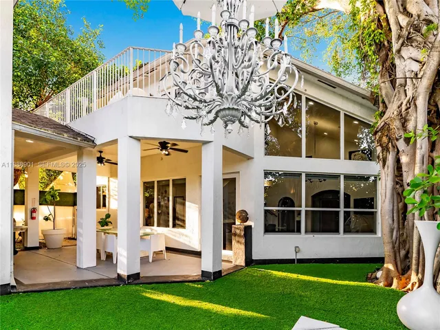 a view of an house with backyard porch and a garden