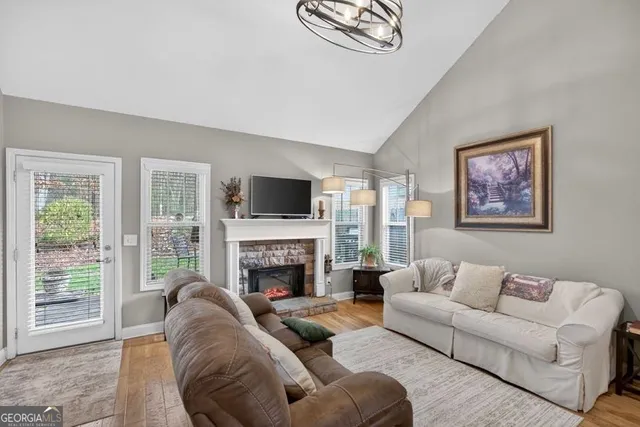 a living room with furniture large window and a fireplace