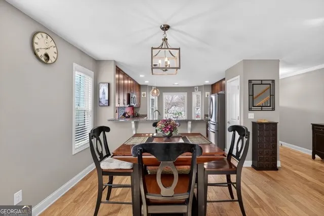 a view of a dining room with furniture and a chandelier