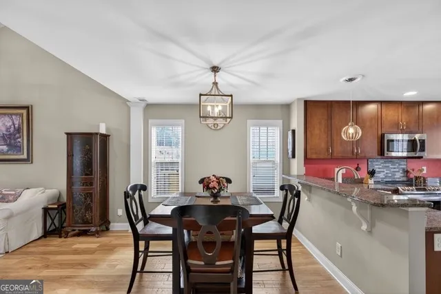 a dining room with a wooden table and chairs