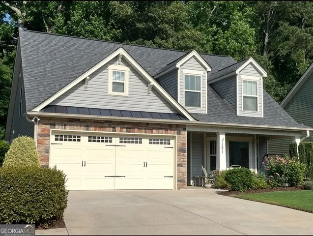 a view of a house with a yard and plants