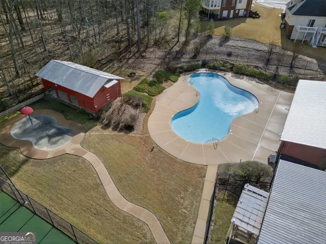 an aerial view of a house with a swimming pool