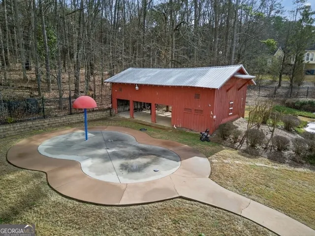 an aerial view of a house with a yard and a large tree