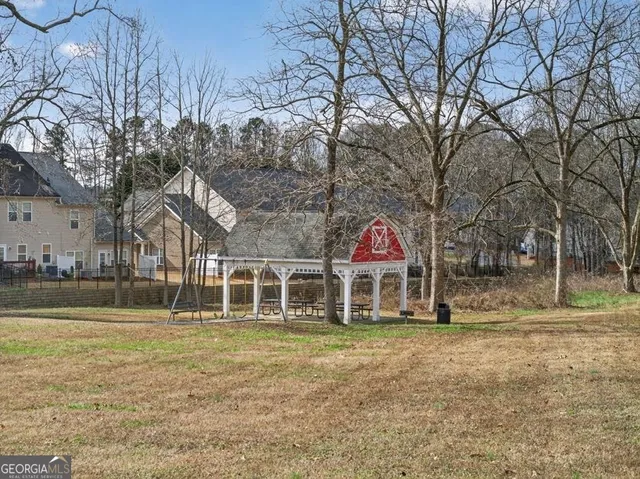 a view of a hallway with wooden floor and stairs