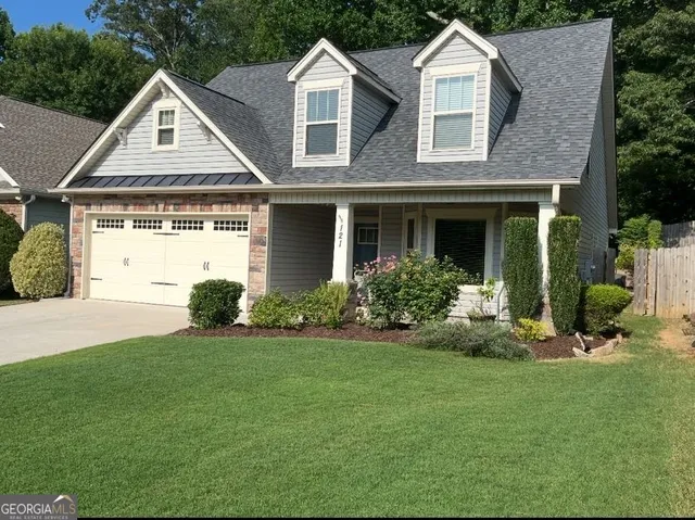 a front view of a house with a yard and porch