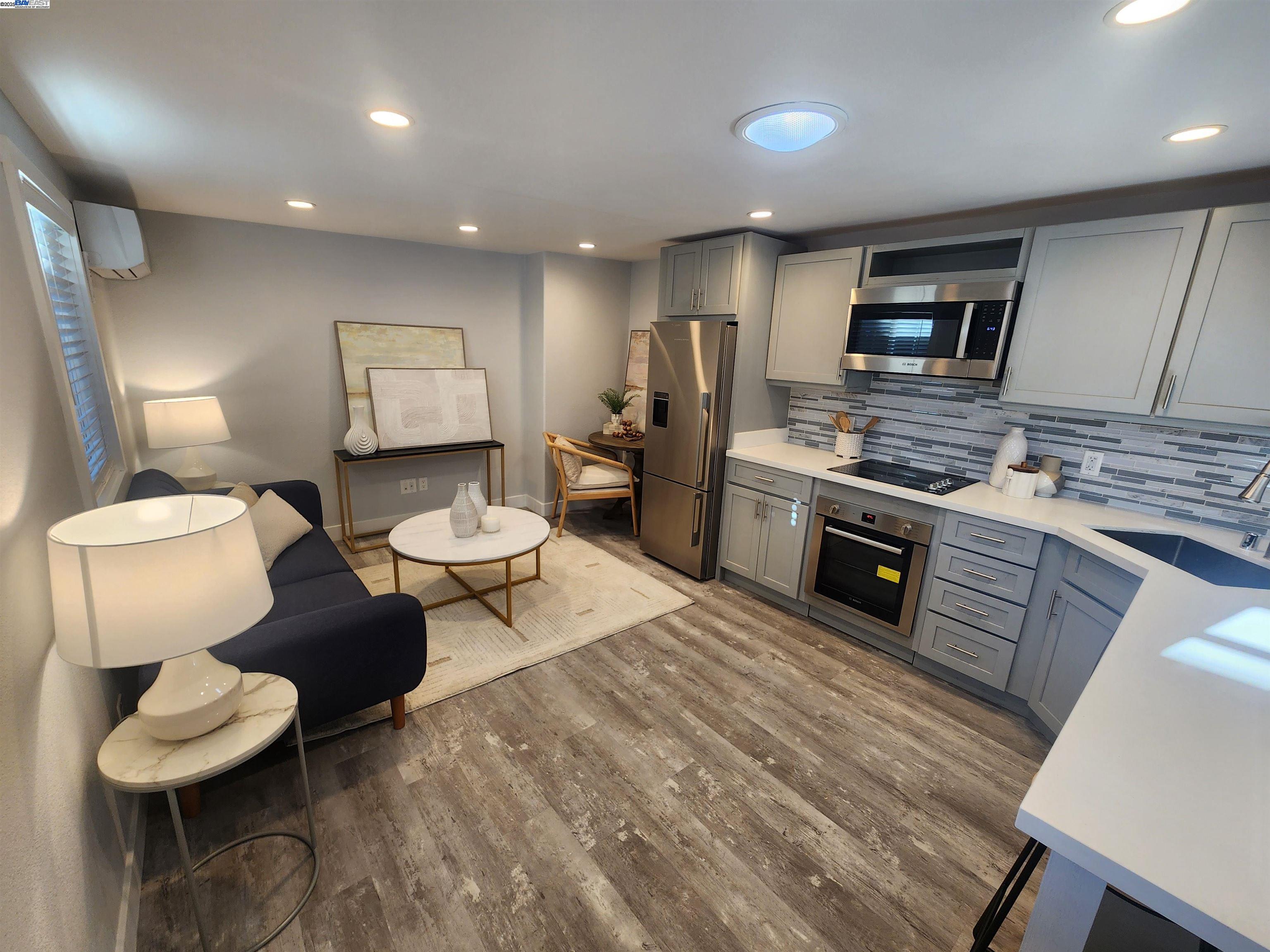 a kitchen with stainless steel appliances kitchen island granite countertop a sink and cabinets