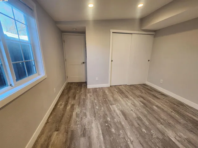 a view of a room with wooden floor and natural light
