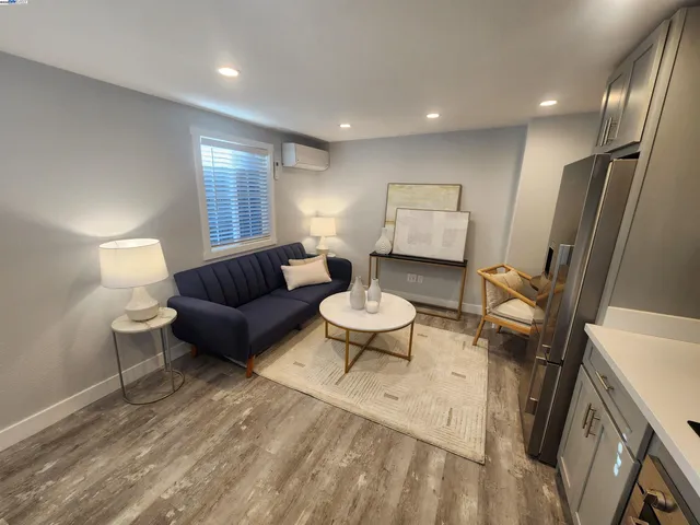 a living room with furniture a mirror and a piano