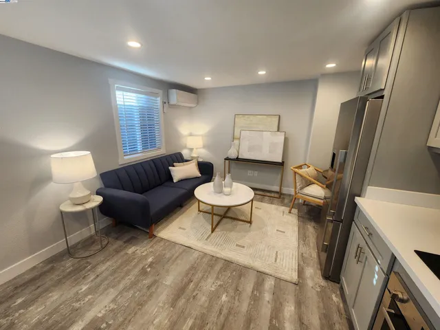 a living room with furniture a mirror and a table